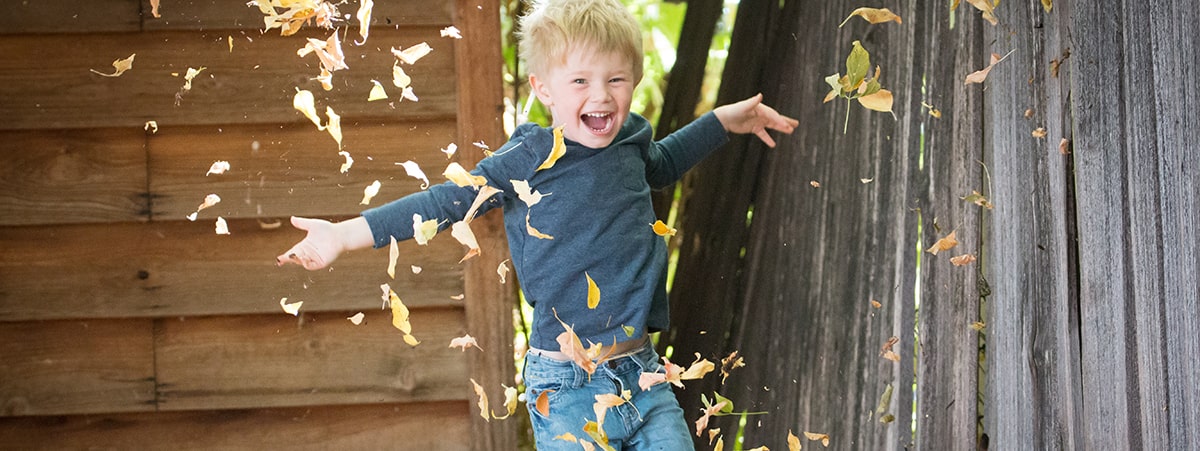 Child-Enjoying-Falling-Leaves